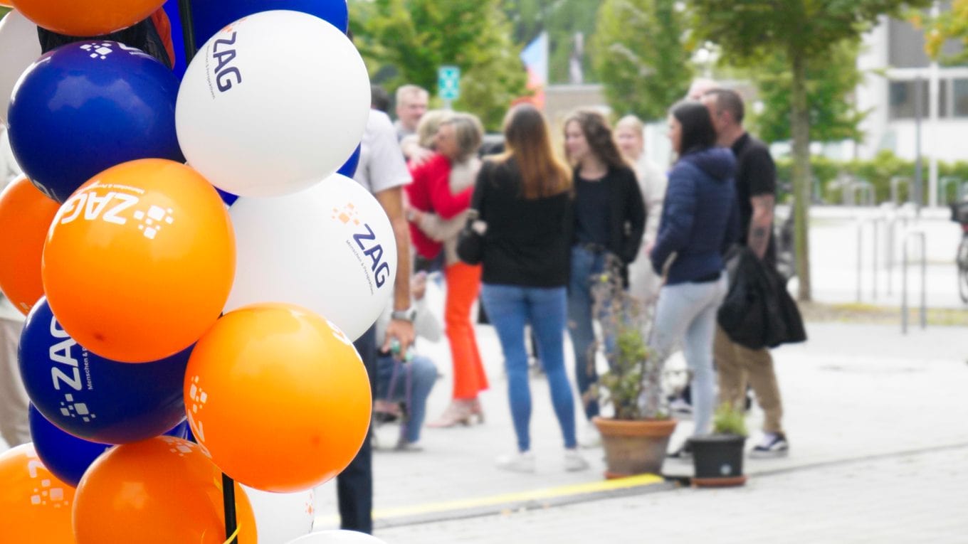 Dipendenti e ospiti alla festa estiva dello ZAG del 2026, circondati da palloncini colorati e da un’atmosfera allegra.